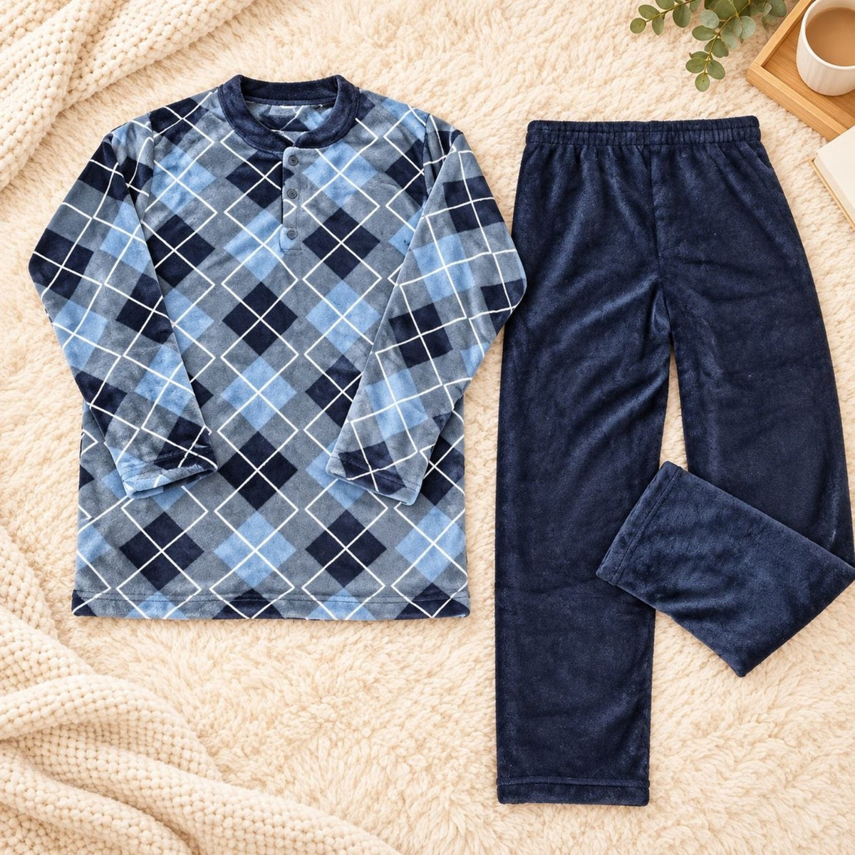 Flat lay of a men's blue argyle warm pajama set with navy fleece pants