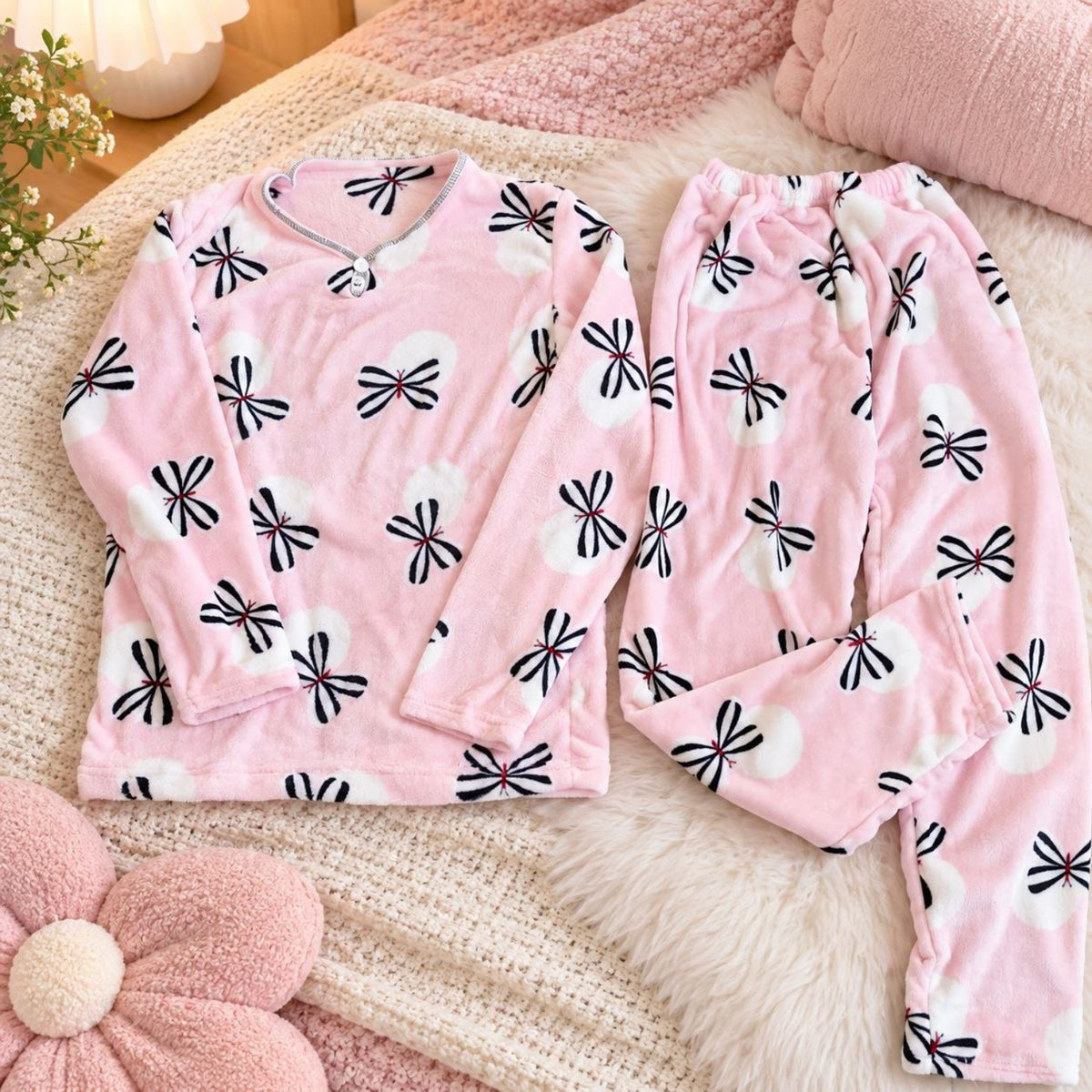 Pink and black floral women's winter pajama top and trousers flat lay