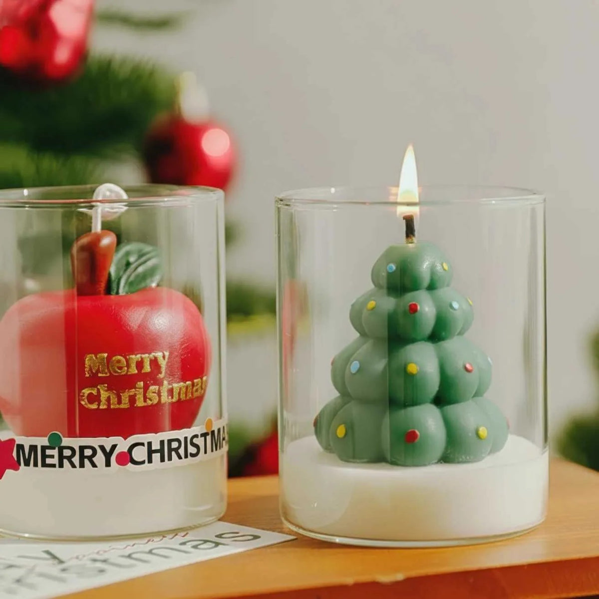 Christmas scented candles in glass - red apple and green Christmas tree
