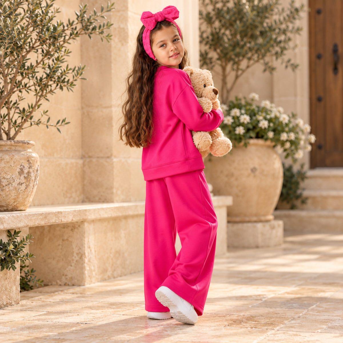 Back and side view of fuchsia girls sweatshirt and wide-leg pants