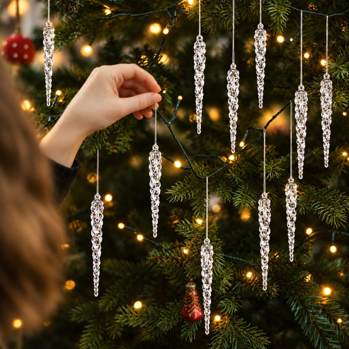 Transparent Christmas icicles on fir branches shown close up