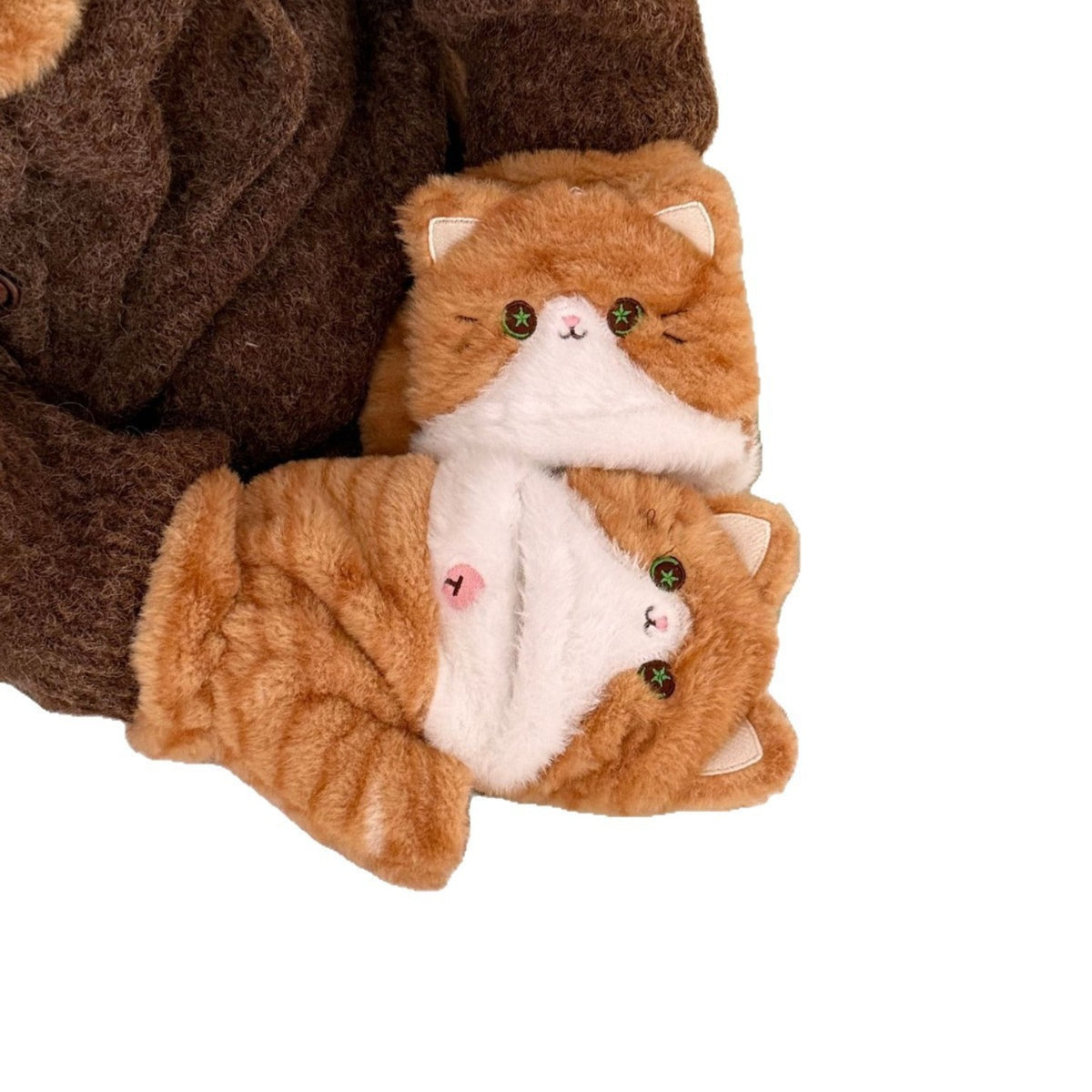 Close-up of matching ginger cat plush convertible mittens with green eyes and foldover gloves