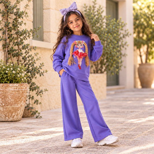 Girl wearing purple sweatshirt with 3D doll applique and matching wide-leg pants, full-length view