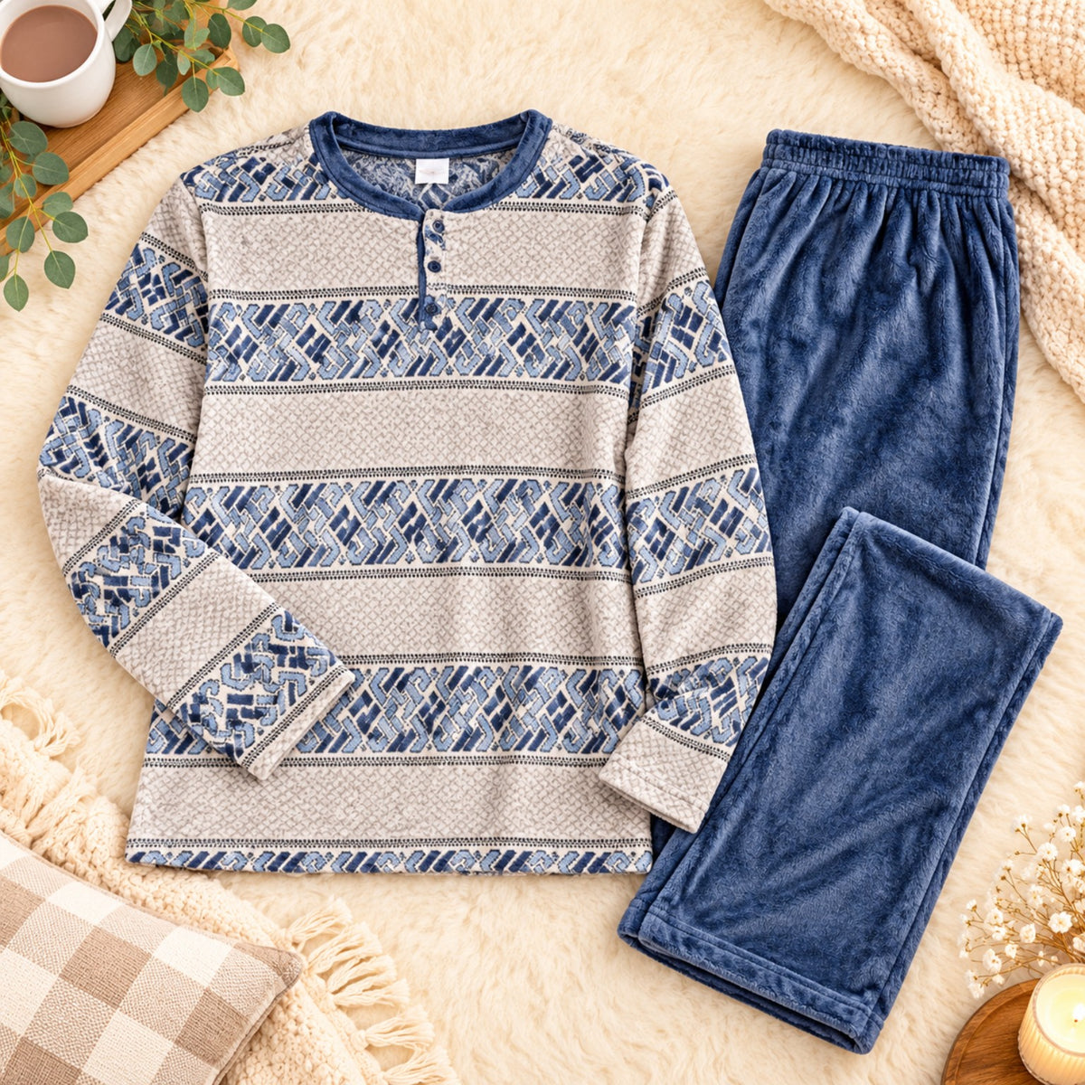 Blue geometric fleece pajama top with plain blue fleece pants laid flat