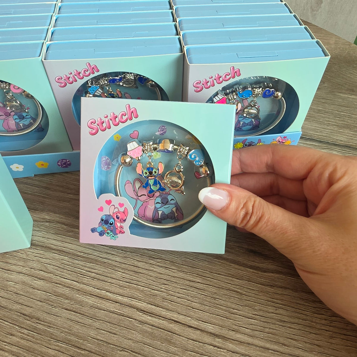 Stitch character bracelet with blue and pink themed charms in gift packaging