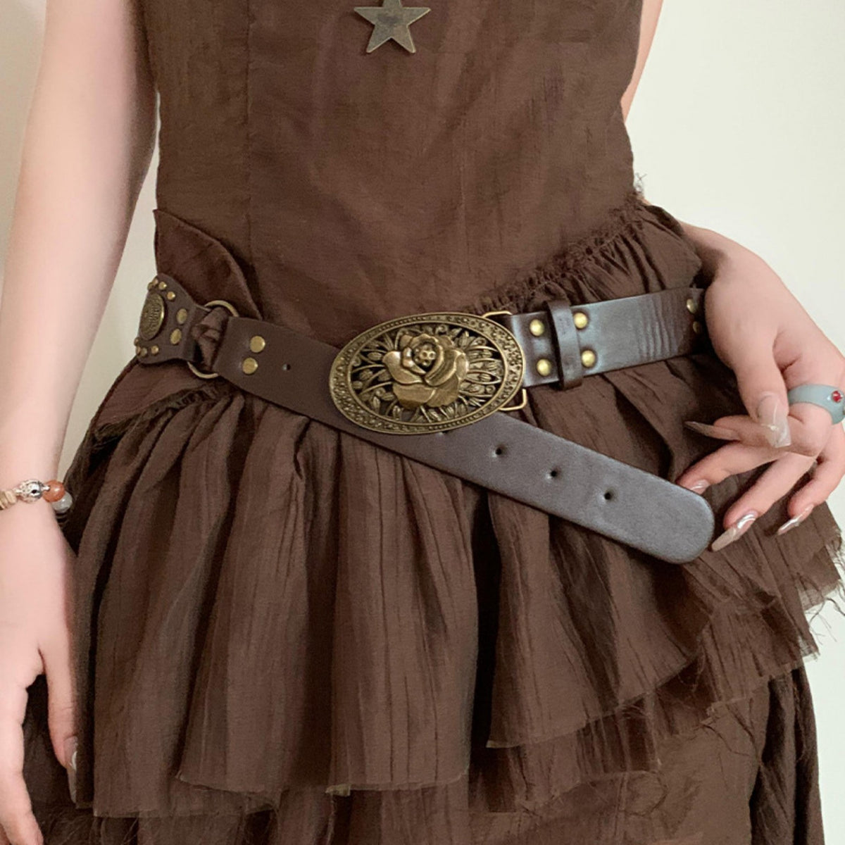Brown rose buckle waist belt worn as a fashion accessory