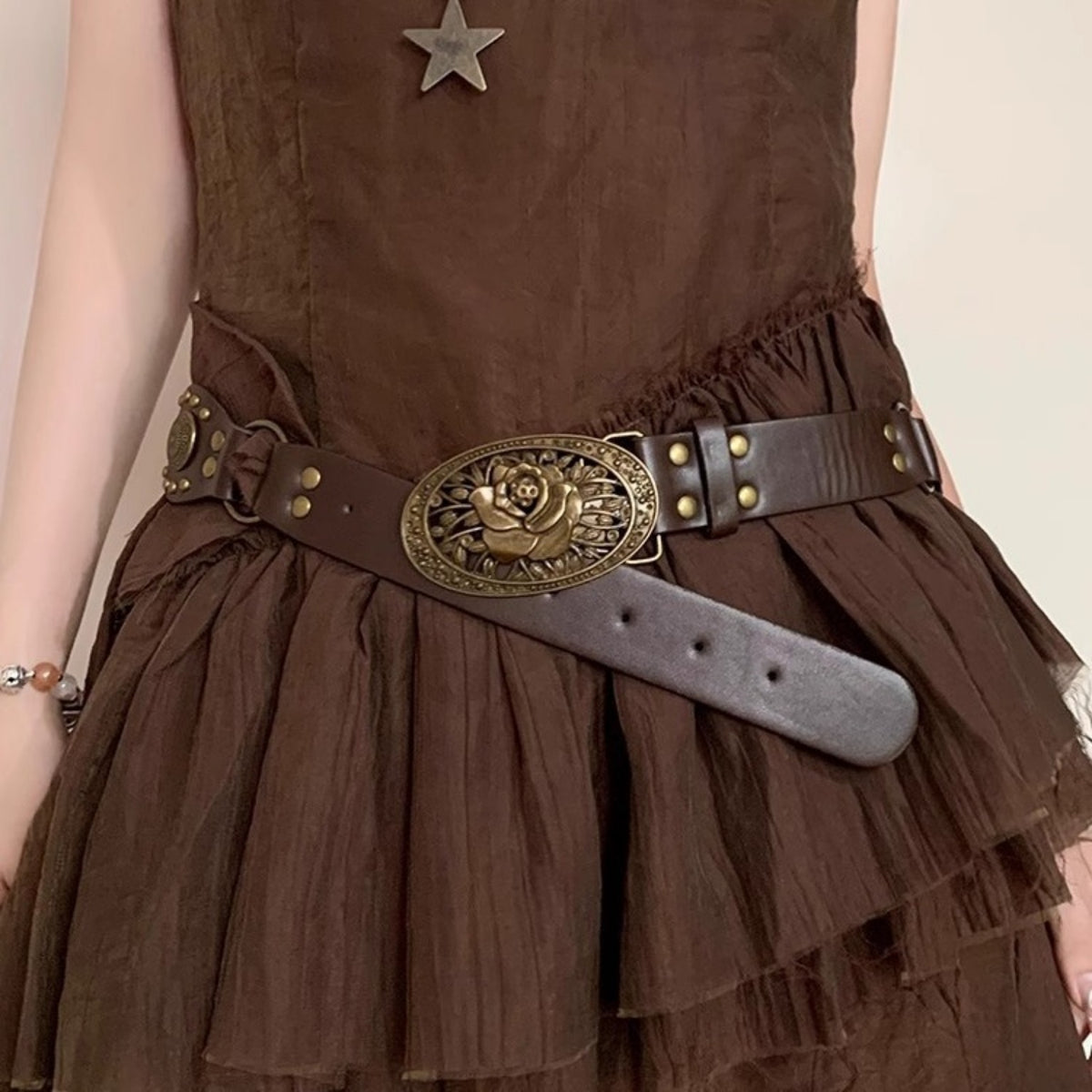 Close-up of vintage flower buckle waist belt with brown dress