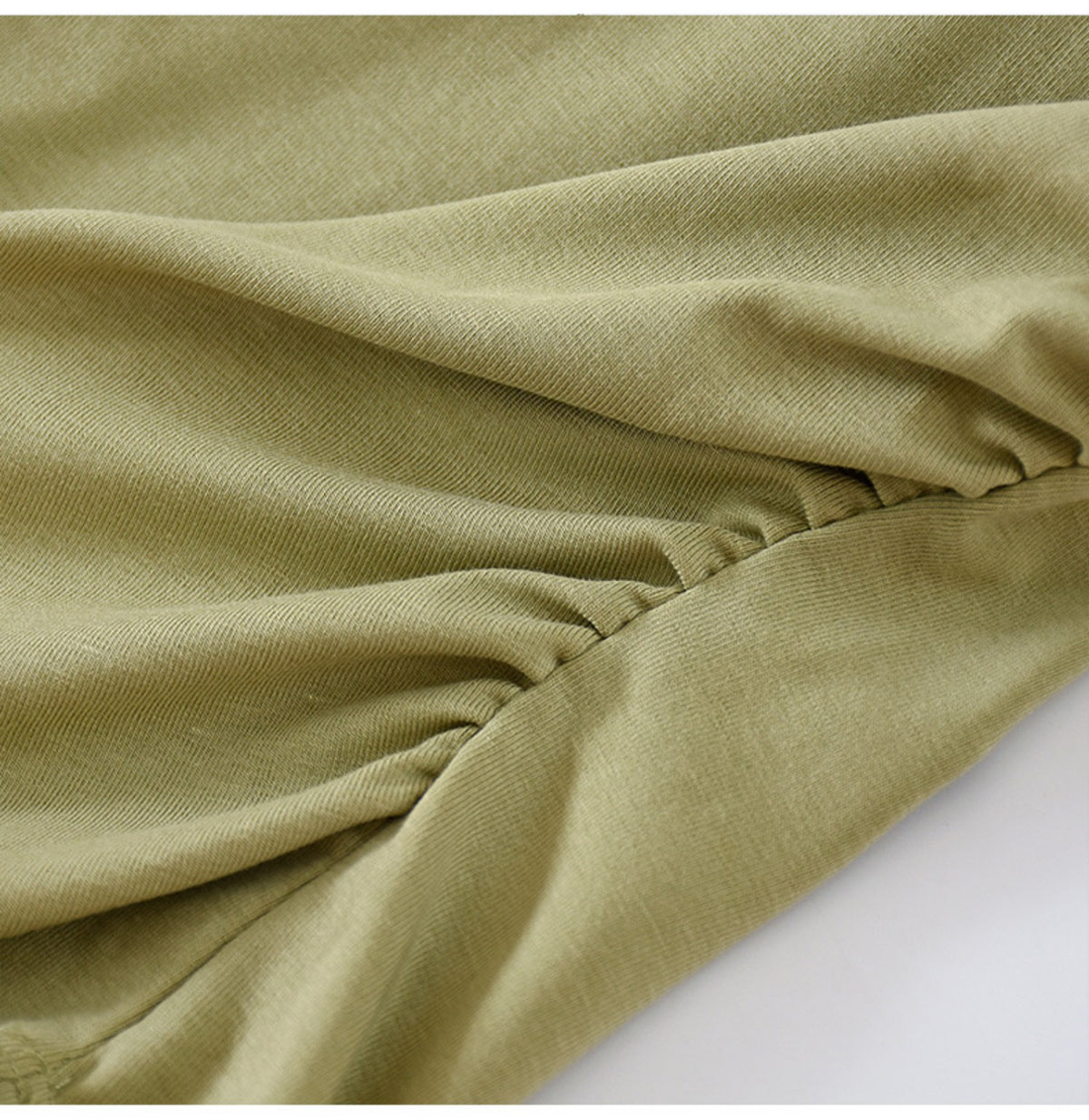 Ruched side detail of sage green long-sleeve top