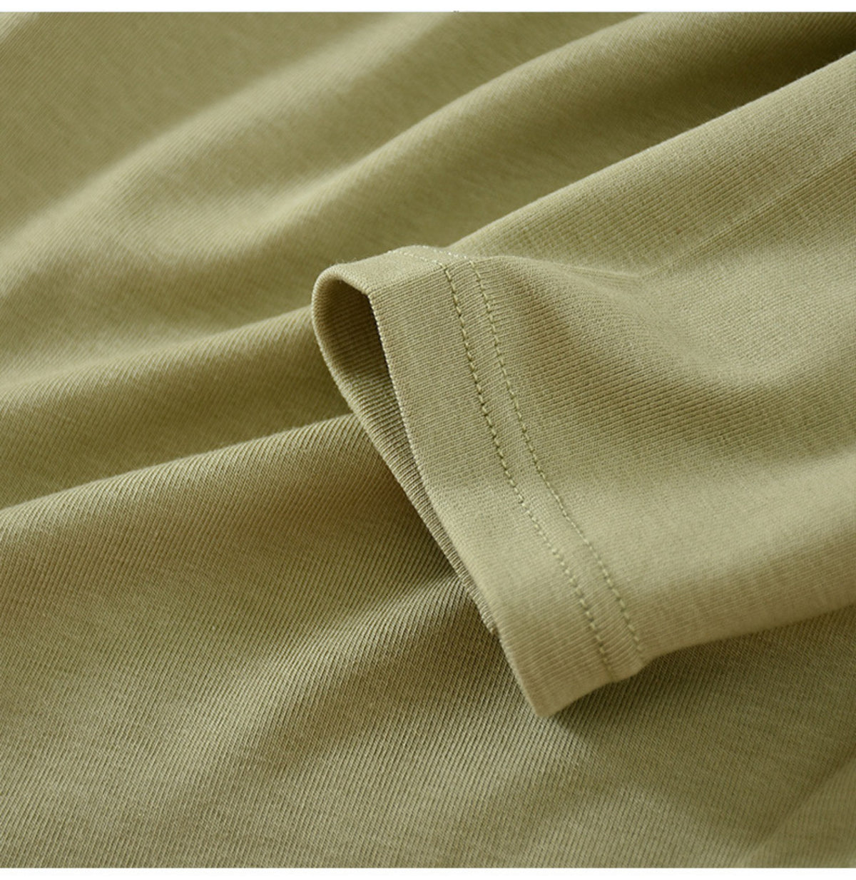 Sage green long-sleeve top cuff and fabric detail