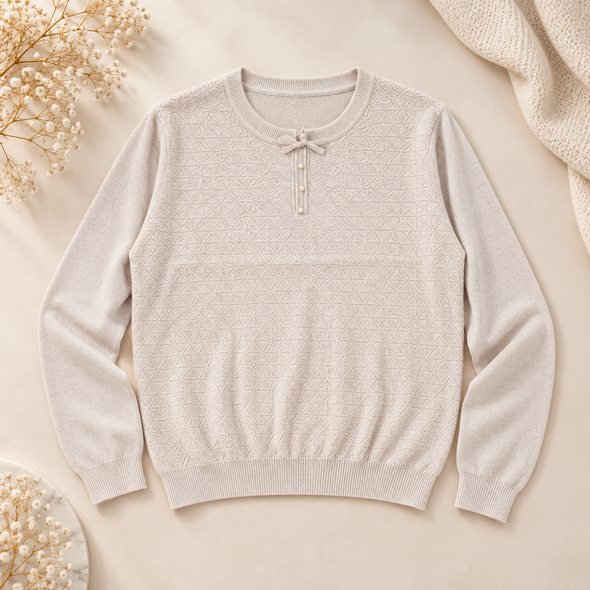 Women's ivory geometric diamond knit sweater, front view on cream backdrop